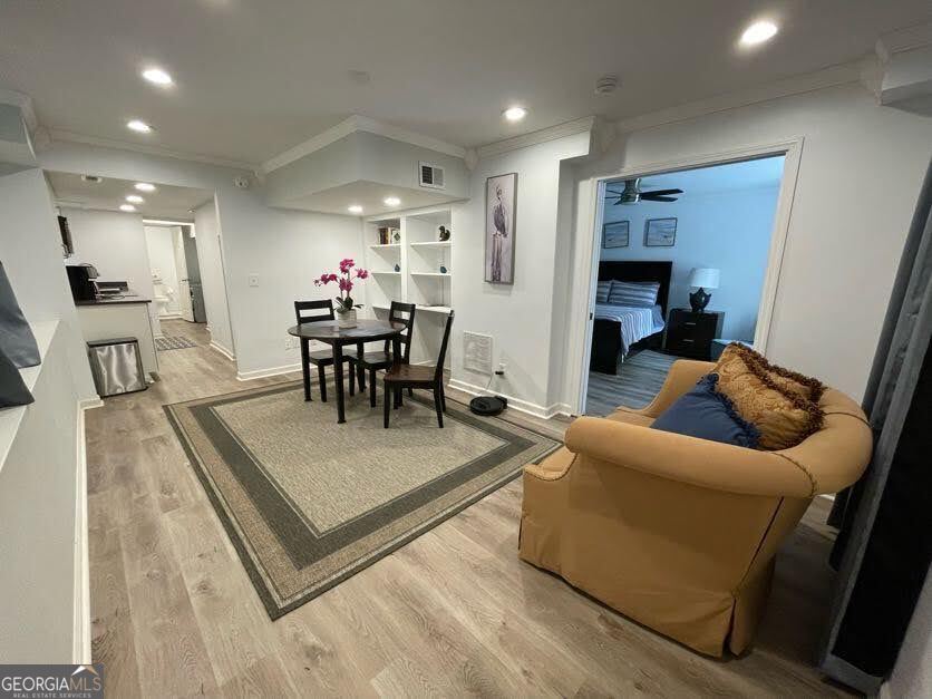 1502 Eryn Circle Suwanee, GA 30024 - Photo 39 of 57 a living room with furniture a table and kitchen view