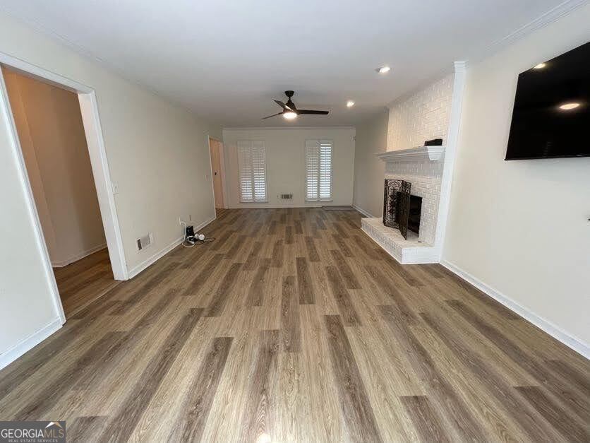 1502 Eryn Circle Suwanee, GA 30024 - Photo 4 of 57 wooden floor in an empty room with a fireplace
