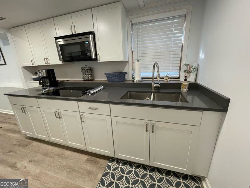 1502 Eryn Circle Suwanee, GA 30024 - Photo 42 of 57 a kitchen with granite countertop white cabinets and a sink