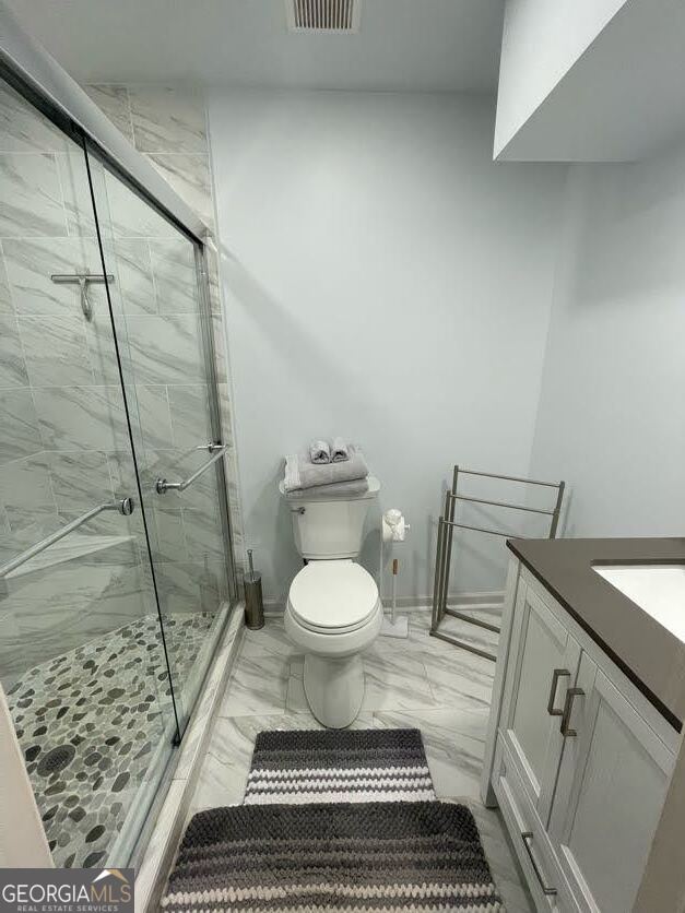 1502 Eryn Circle Suwanee, GA 30024 - Photo 44 of 57 a bathroom with a toilet a sink and a shower