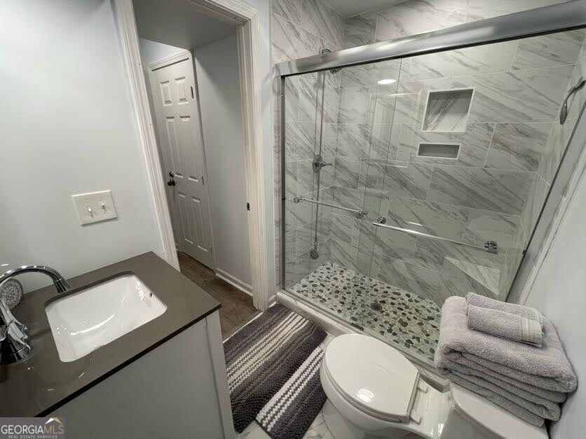 1502 Eryn Circle Suwanee, GA 30024 - Photo 45 of 57 a bathroom with a granite countertop sink mirror vanity and toilet