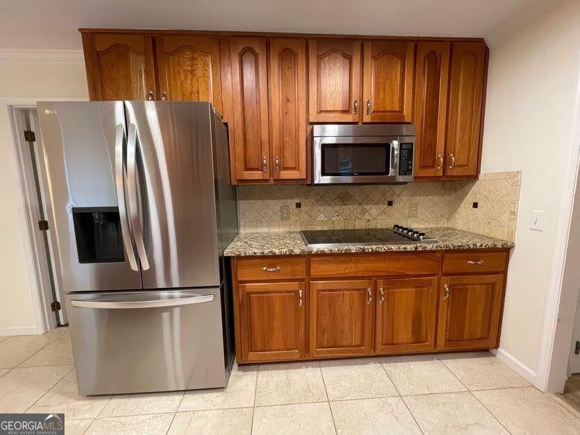 1502 Eryn Circle Suwanee, GA 30024 - Photo 5 of 57 a kitchen with granite countertop a refrigerator and a stove top oven