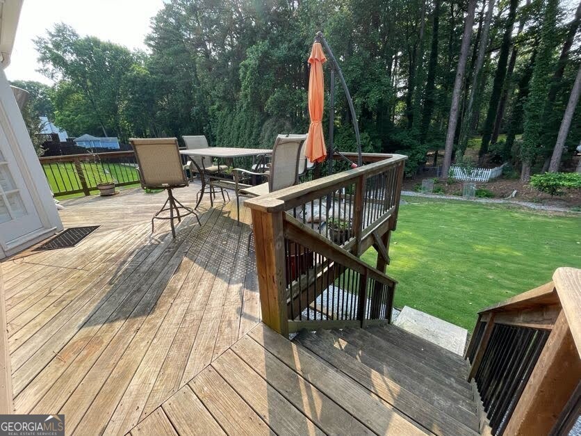 1502 Eryn Circle Suwanee, GA 30024 - Photo 51 of 57 a view of a deck with chairs and wooden floor