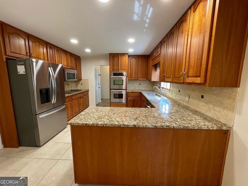 1502 Eryn Circle Suwanee, GA 30024 - Photo 7 of 57 a kitchen with kitchen island granite countertop wooden cabinets a refrigerator and a sink