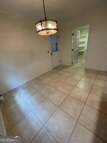 a view of a room with a chandelier and stove