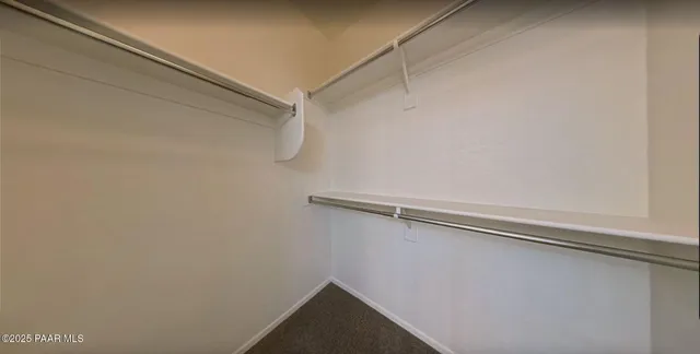 an empty room with windows and chandelier