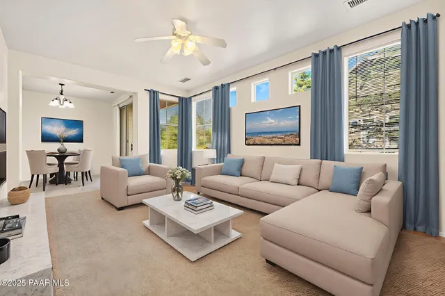 an empty room with a chandelier fan