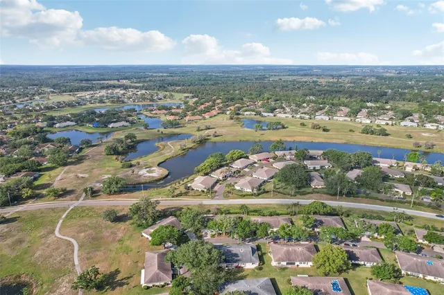 an aerial view of residential building and lake