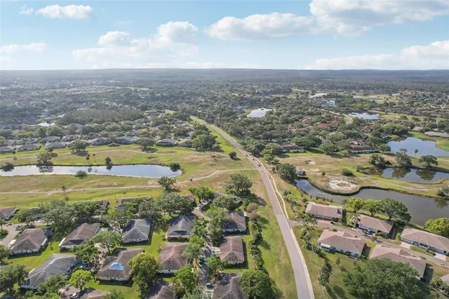 an aerial view of residential building and lake