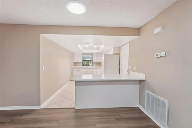 a kitchen with white cabinets and white appliances