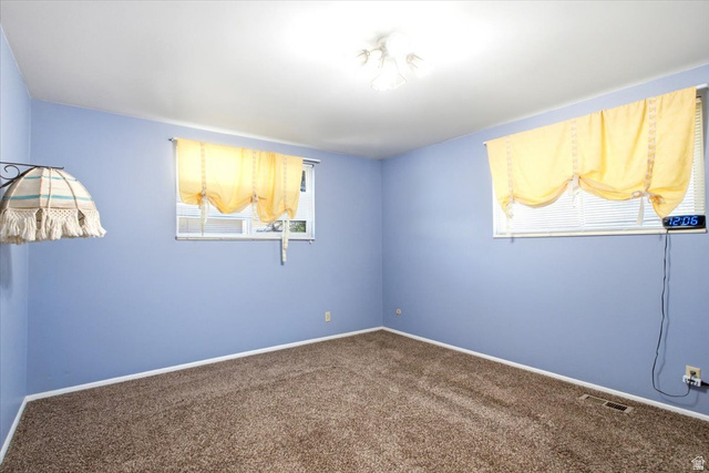 7050 South 260 East Midvale, UT 84047 - Photo 18 of 28 Room with wall-to-wall carpeting, light blue painted walls, and white baseboards