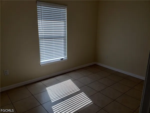 a view of an empty room and a window