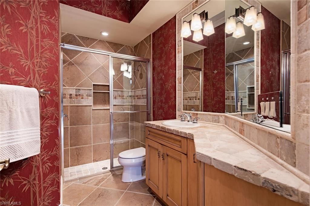 14906 Bellezza Lane Naples, FL 34110 - Photo 13 of 33 a bathroom with a granite countertop sink mirror vanity and toilet