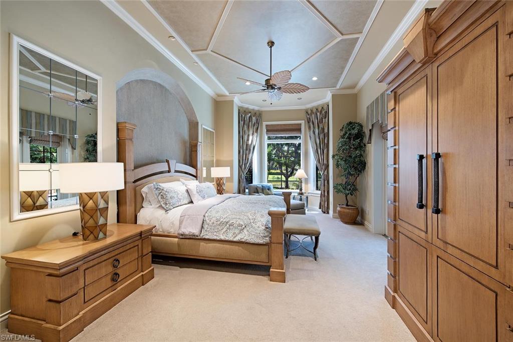 14906 Bellezza Lane Naples, FL 34110 - Photo 16 of 33 a spacious bedroom with a bed couch and a window