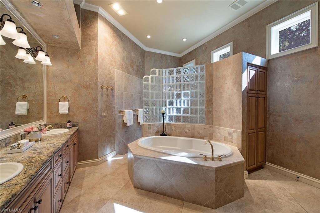 14906 Bellezza Lane Naples, FL 34110 - Photo 17 of 33 a bath tub sitting in a bathroom next to a sink