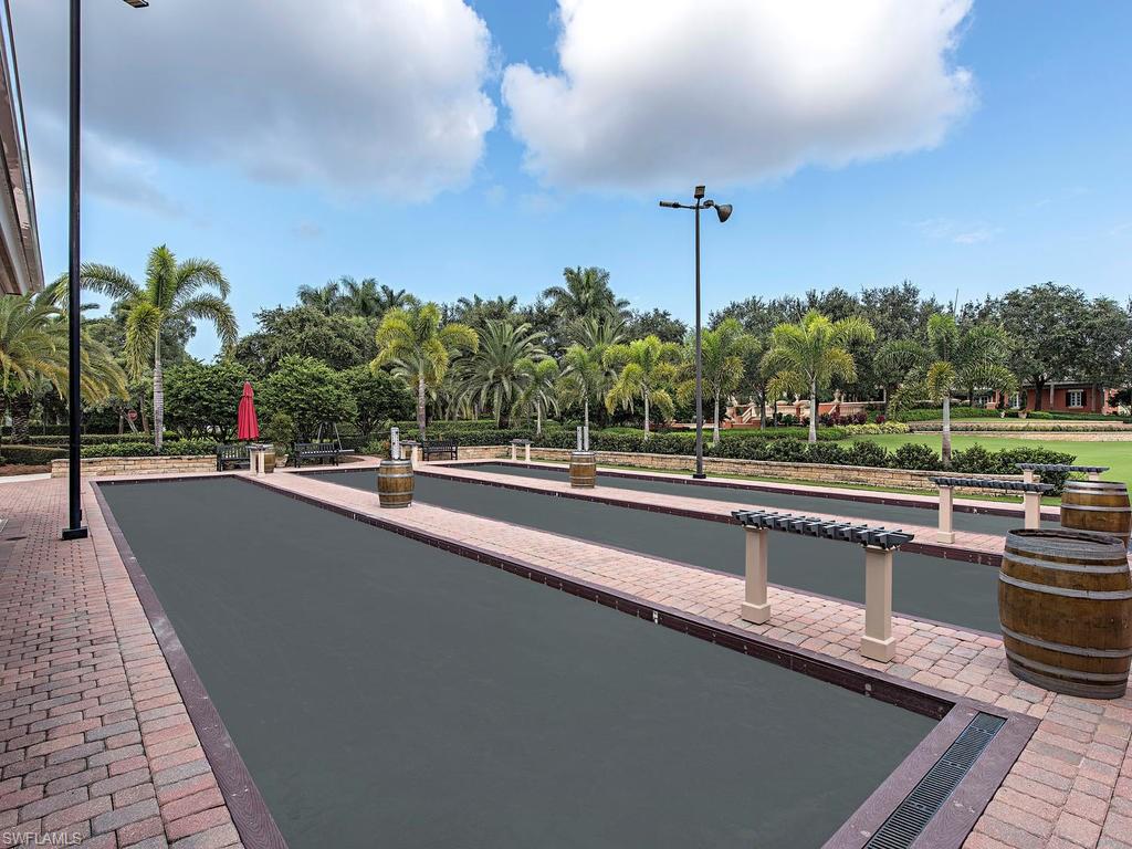 14906 Bellezza Lane Naples, FL 34110 - Photo 27 of 33 a view of a swimming pool with a lawn chairs