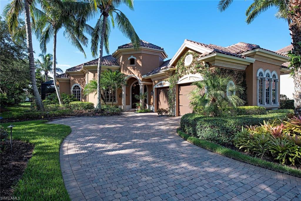 14906 Bellezza Lane Naples, FL 34110 - Photo 3 of 33 a view of a white house with a clock tower in the middle