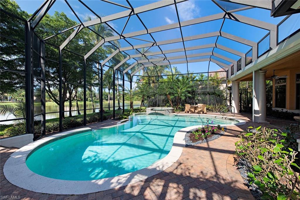 14906 Bellezza Lane Naples, FL 34110 - Photo 5 of 33 a view of a swimming pool with a patio