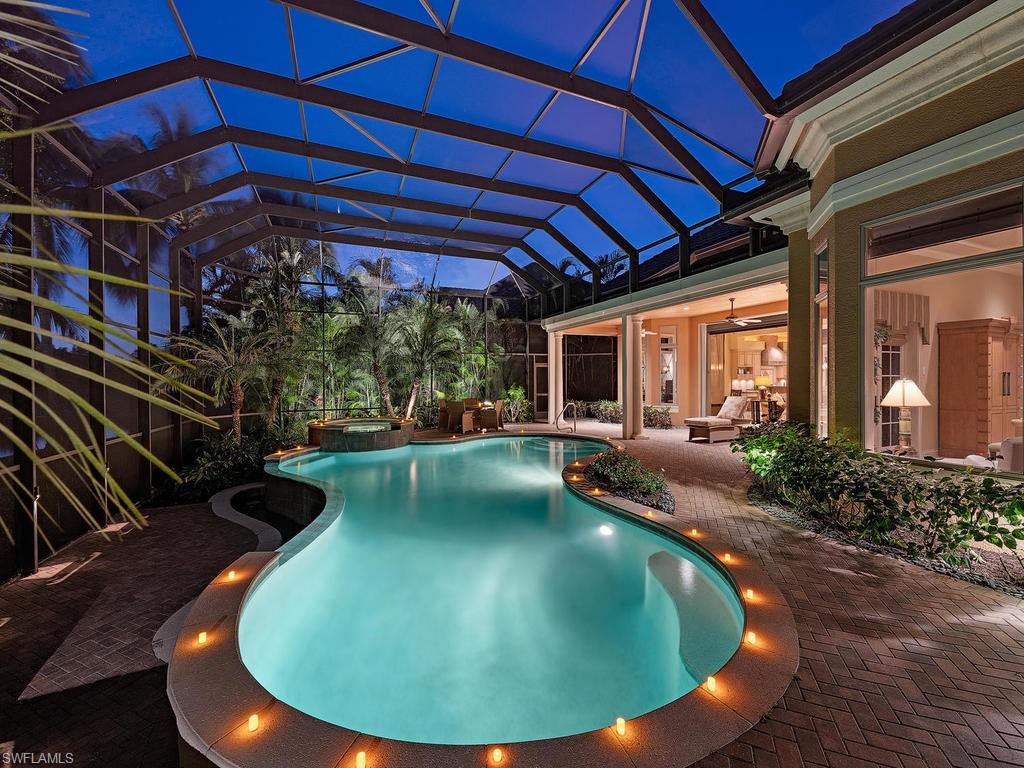 14906 Bellezza Lane Naples, FL 34110 - Photo 6 of 33 a view of a swimming pool with a patio