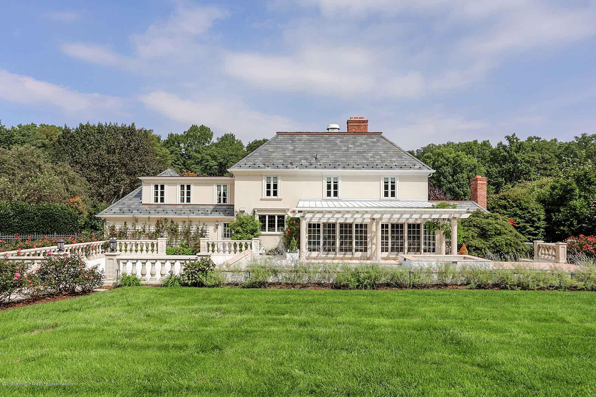 6 Woods End Road Rumson, NJ 07760 - Photo 6 of 43 a front view of a house with a garden