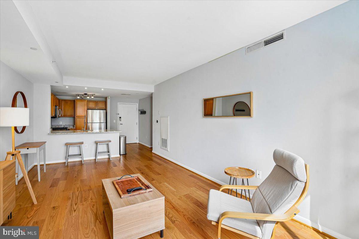 350 G Street Southwest, Unit N511 Washington, DC 20024 - Photo 12 of 27 a living room with furniture and a flat screen tv