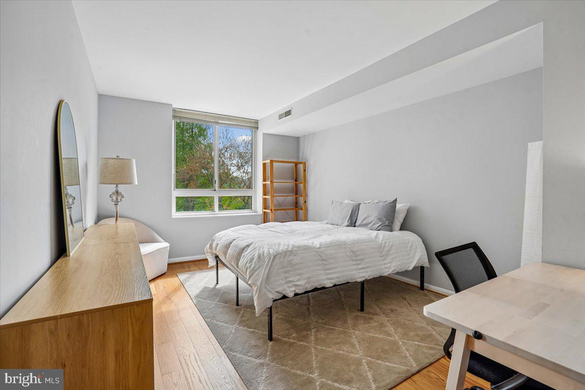 350 G Street Southwest, Unit N511 Washington, DC 20024 - Photo 14 of 27 a bedroom with a bed window and table