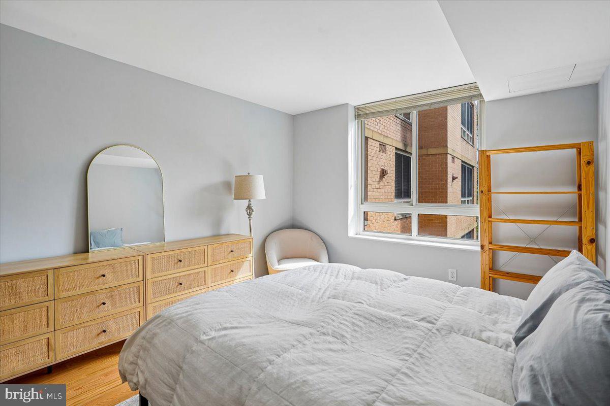 350 G Street Southwest, Unit N511 Washington, DC 20024 - Photo 15 of 27 a bedroom with a bed and a large window