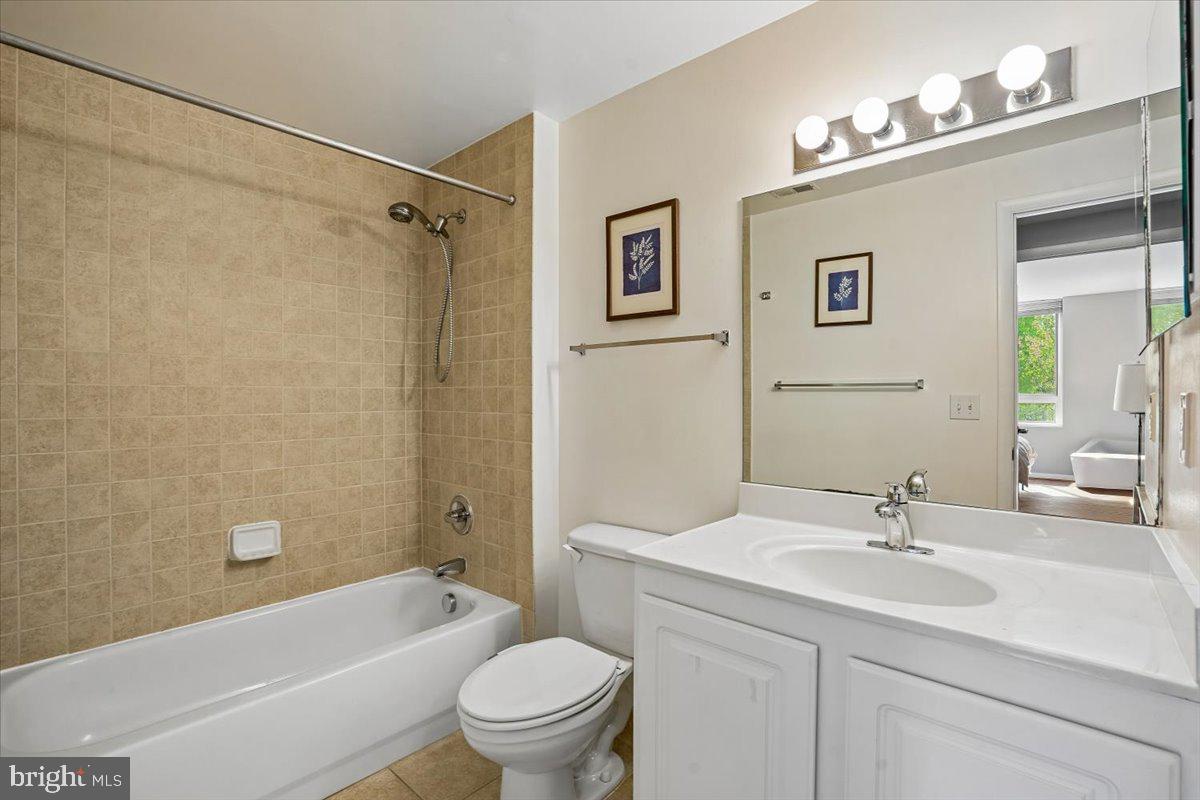 350 G Street Southwest, Unit N511 Washington, DC 20024 - Photo 19 of 27 a bathroom with a granite countertop sink a toilet and a bathtub