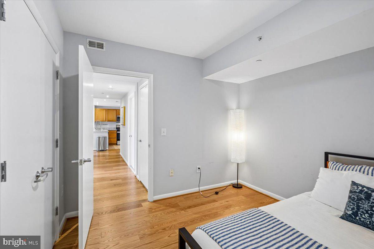350 G Street Southwest, Unit N511 Washington, DC 20024 - Photo 22 of 27 a bedroom with a bed and a lamp