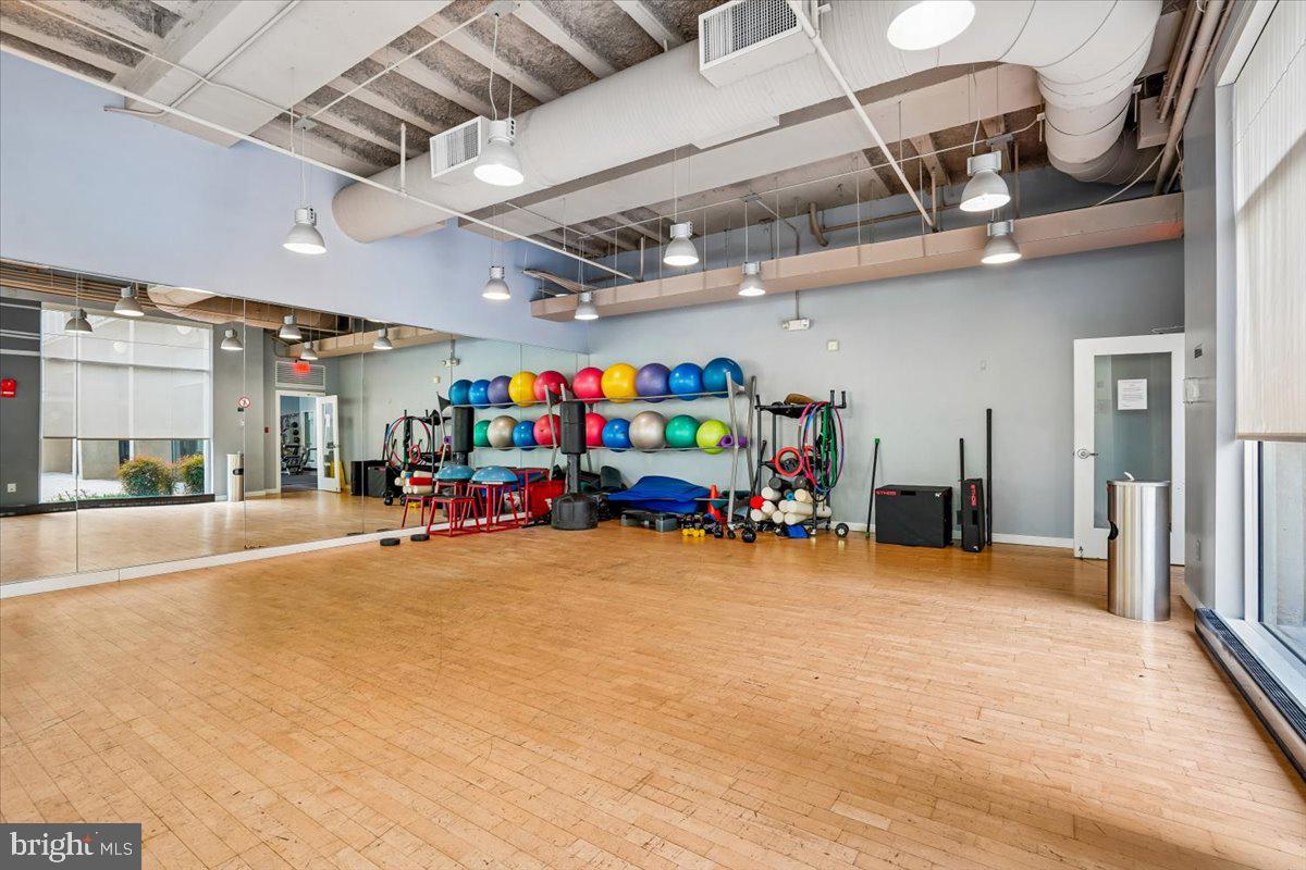 350 G Street Southwest, Unit N511 Washington, DC 20024 - Photo 26 of 27 a view of a garage with a flat screen tv and a large mirror with a fireplace