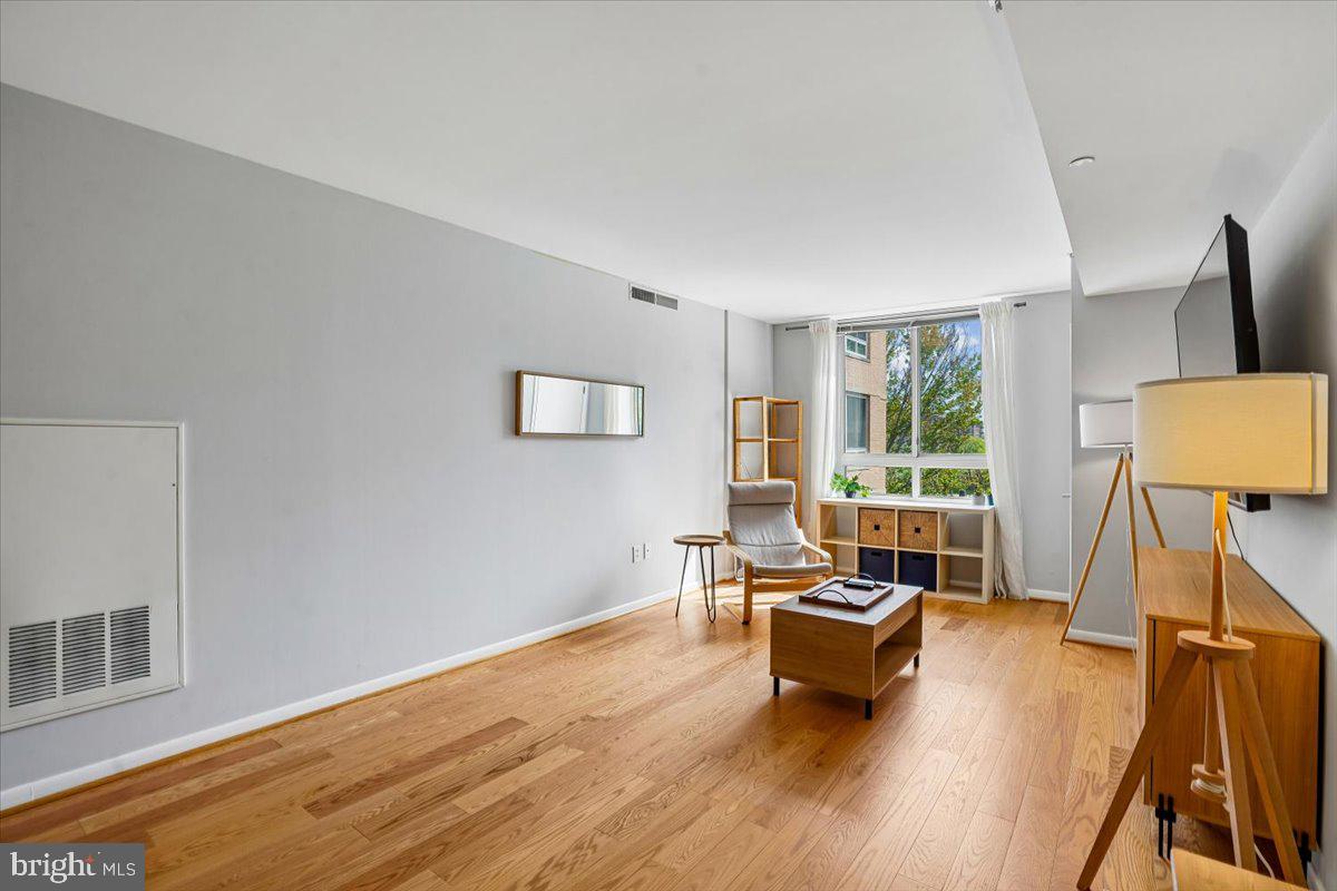 350 G Street Southwest, Unit N511 Washington, DC 20024 - Photo 9 of 27 a living room with furniture and a large window