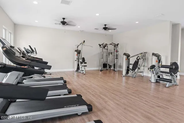 a living room with furniture a rug potted plant and a large window