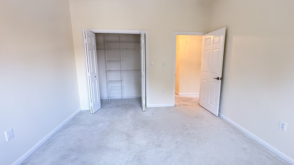 8 Ledgewood Way, Unit 20 Peabody, MA 01960 - Photo 17 of 37 a view of an empty room and closet area