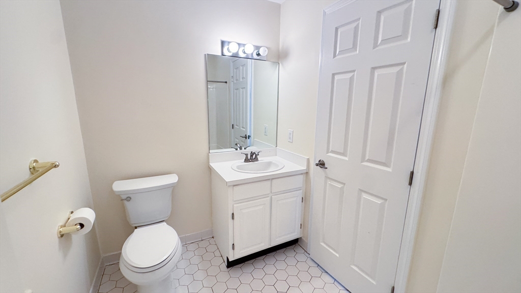 8 Ledgewood Way, Unit 20 Peabody, MA 01960 - Photo 18 of 37 a bathroom with a toilet a sink a vanity and mirror