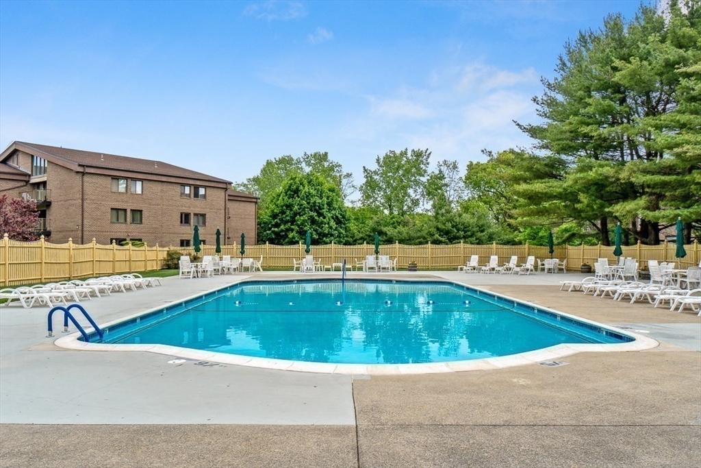 8 Ledgewood Way, Unit 20 Peabody, MA 01960 - Photo 35 of 37 a view of swimming pool with outdoor seating and house in the background