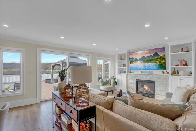 a living room with furniture a fireplace and a flat screen tv