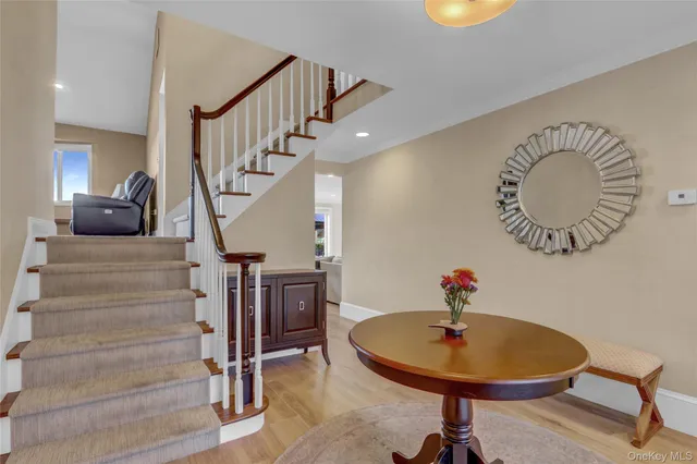 a view of hall way with furniture and wooden floor