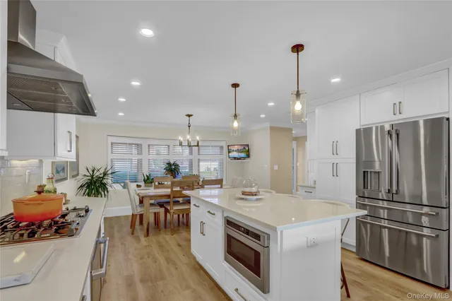 a kitchen with a stove a refrigerator and a table