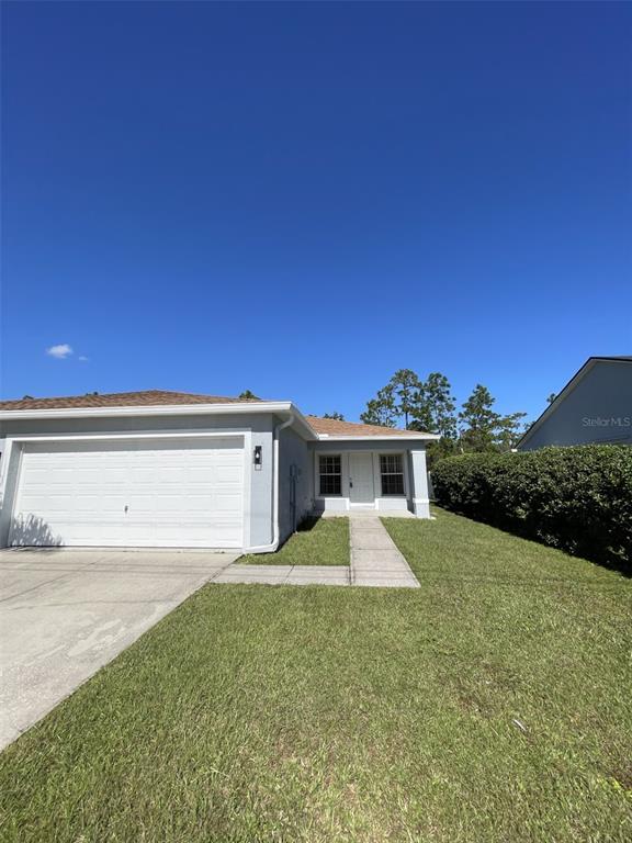 903 Albertville Court, Unit B Kissimmee, FL 34759 - Photo 1 of 1 a view of a house with a yard and potted plants