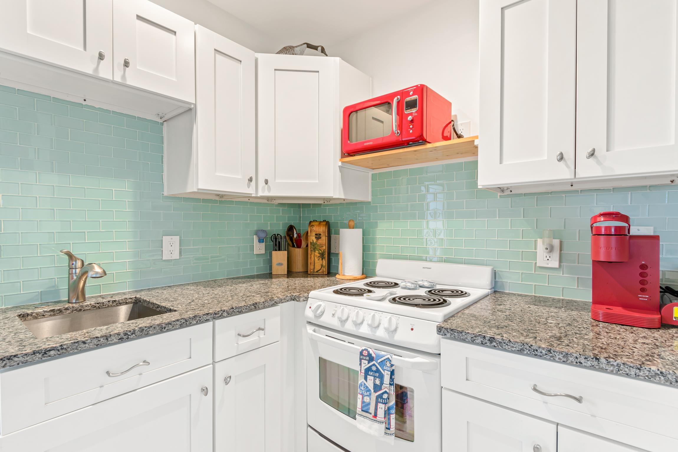 298 Majorca Road St. Augustine, FL 32080 - Photo 22 of 40 a kitchen with granite countertop white cabinets and sink