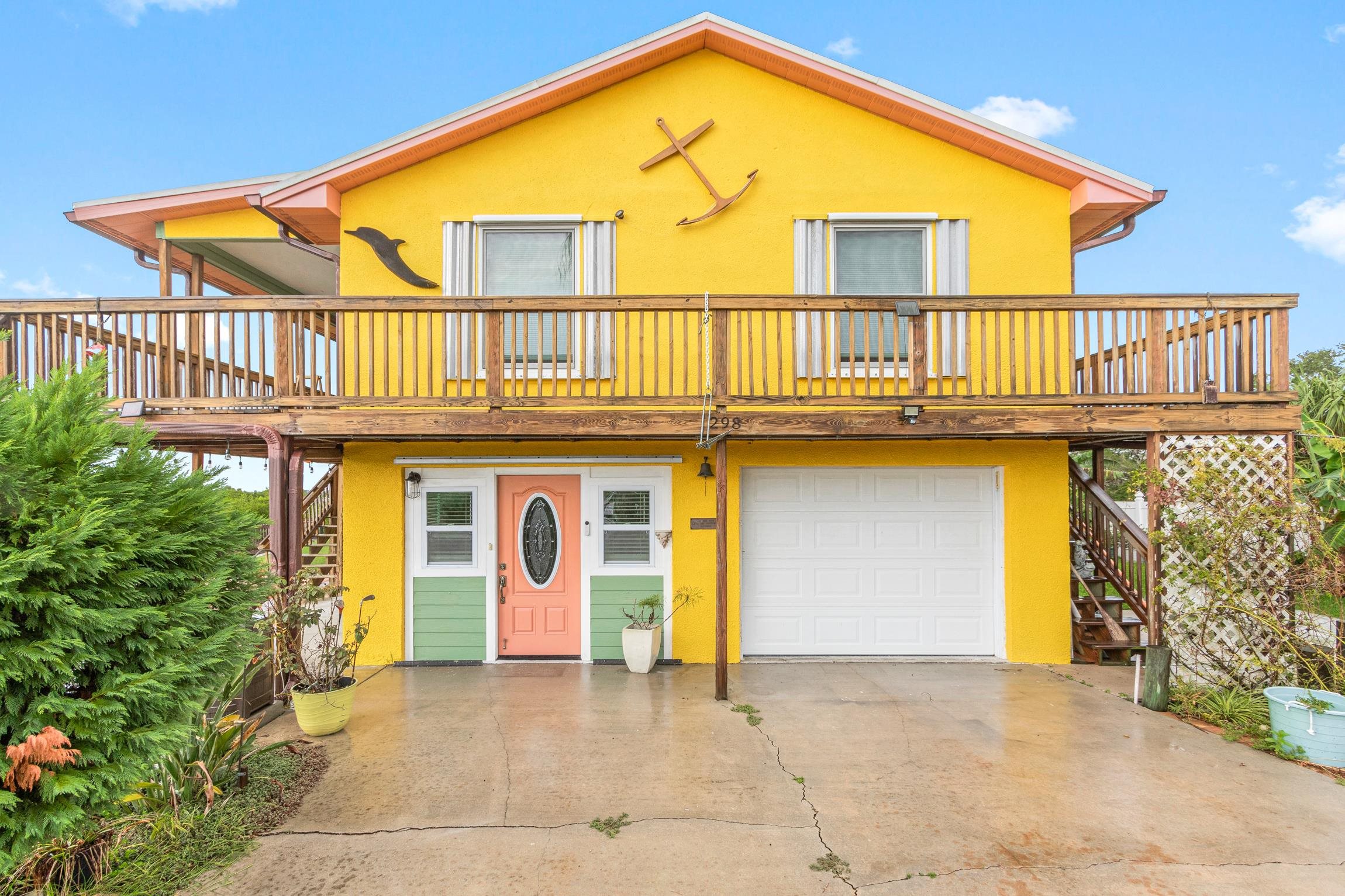 298 Majorca Road St. Augustine, FL 32080 - Photo 5 of 40 a front view of a house with barbeque and wooden floor