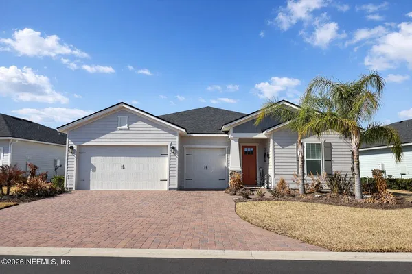 a view of a house with a yard and garage