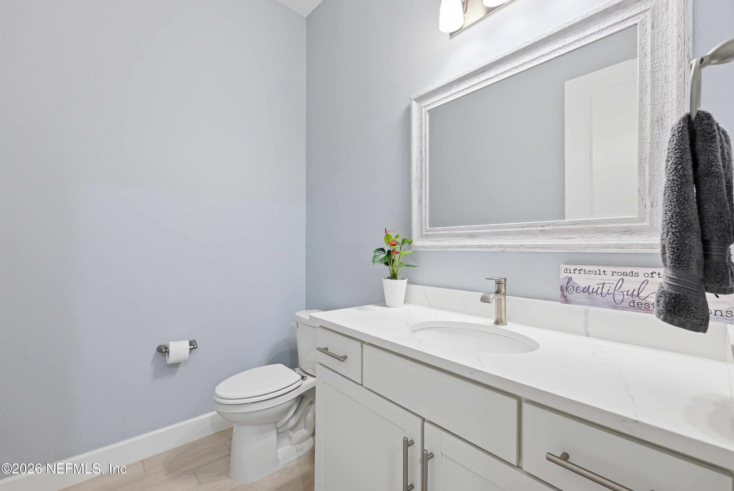 408 Rustic Mill Drive St. Augustine, FL 32092 - Photo 11 of 31 a bathroom with a sink a toilet and mirror