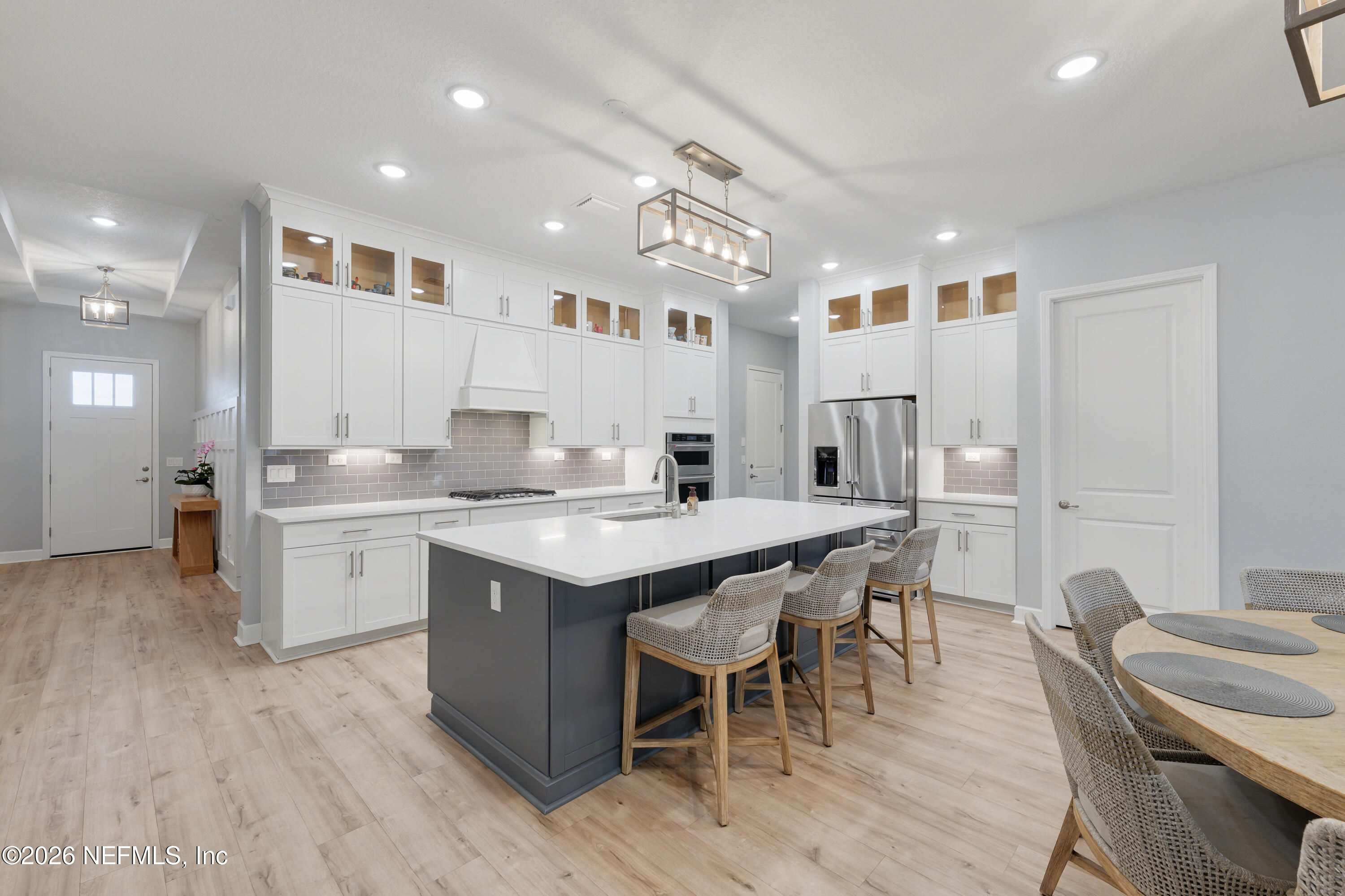 408 Rustic Mill Drive St. Augustine, FL 32092 - Photo 13 of 31 a large kitchen with kitchen island a sink table and chairs