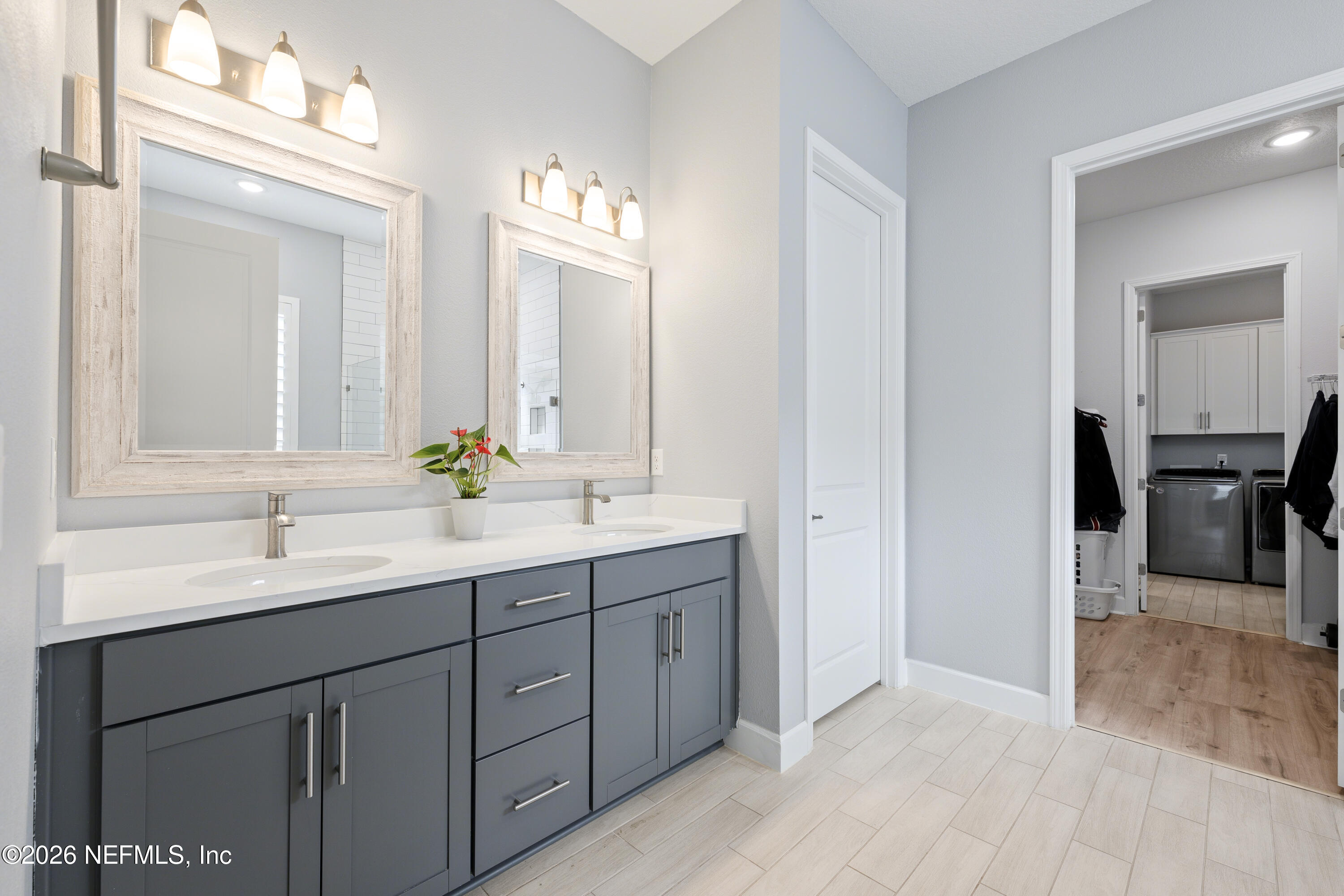408 Rustic Mill Drive St. Augustine, FL 32092 - Photo 24 of 31 a bathroom with a double vanity sink and a mirror