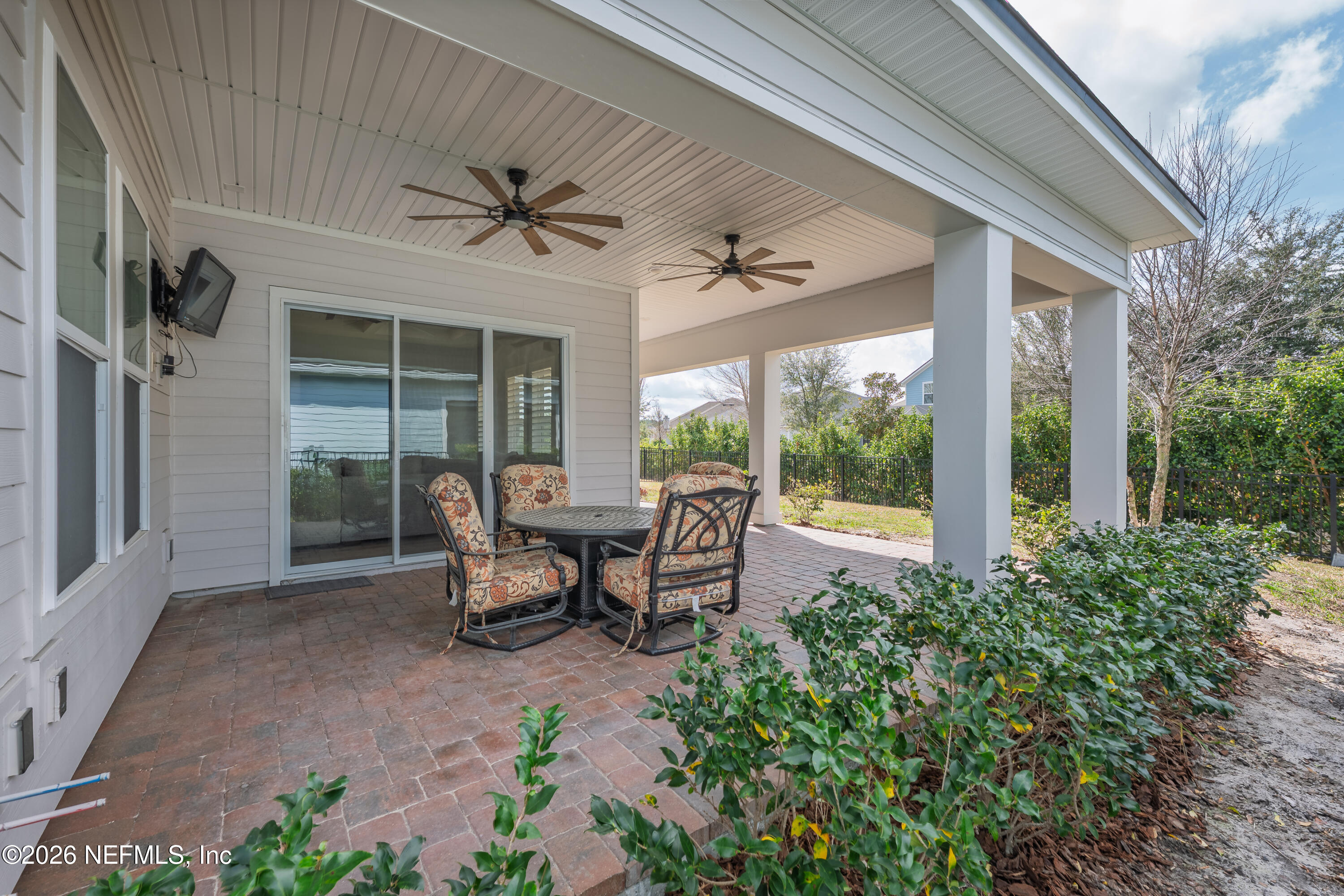 408 Rustic Mill Drive St. Augustine, FL 32092 - Photo 28 of 31 a view of a patio with table and chairs and potted plants