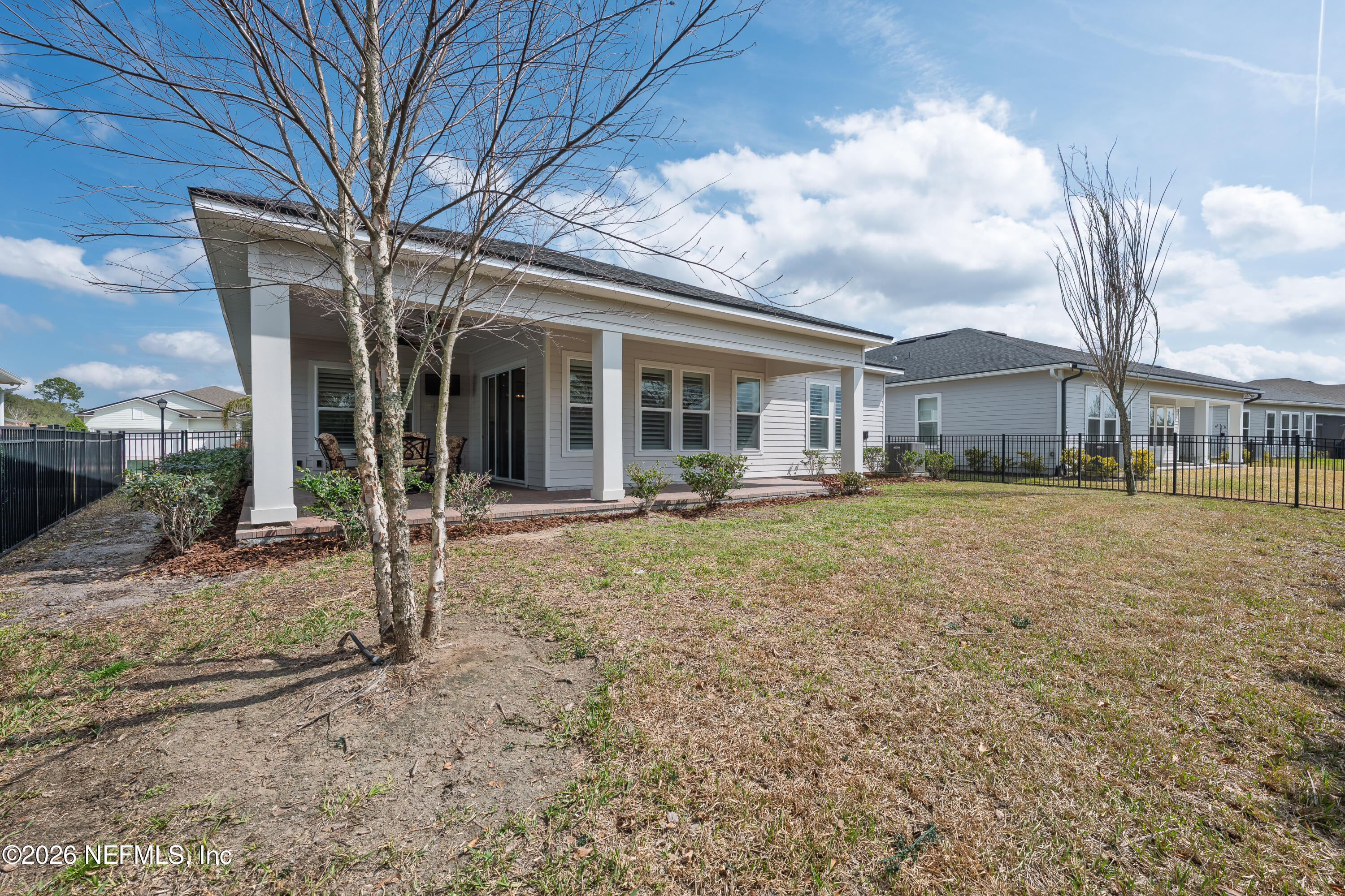 408 Rustic Mill Drive St. Augustine, FL 32092 - Photo 29 of 31 a view of a house with a backyard and porch