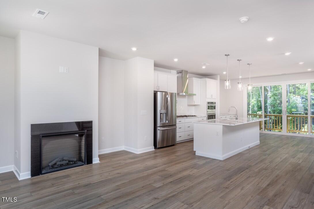 4703 Mint Leaf Lane Raleigh, NC 27612 - Photo 14 of 25 a view of kitchen with stainless steel appliances refrigerator stove microwave and cabinets