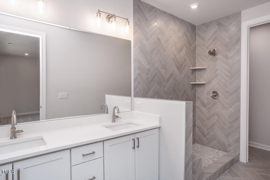 4703 Mint Leaf Lane Raleigh, NC 27612 - Photo 20 of 25 a bathroom with a sink and a mirror