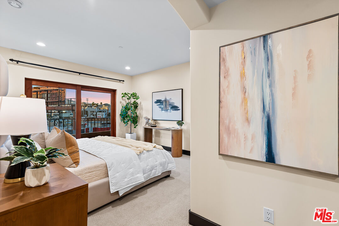 1215 Armacost Avenue, Unit 403 Los Angeles, CA 90025 - Photo 11 of 25 a bedroom with a bed and a large window